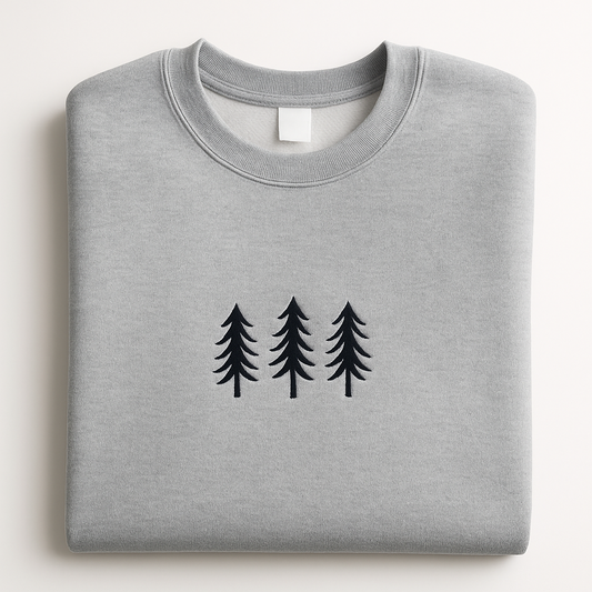 Folded gray sweatshirt with black tree design on a white background