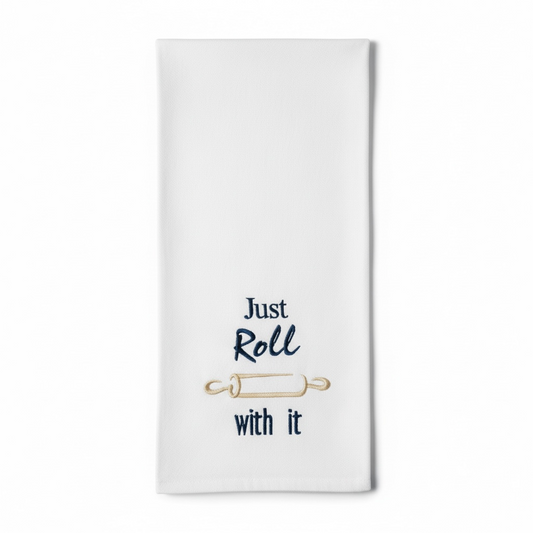 White towel with 'Just Roll with It' text and rolling pin graphic on a white background